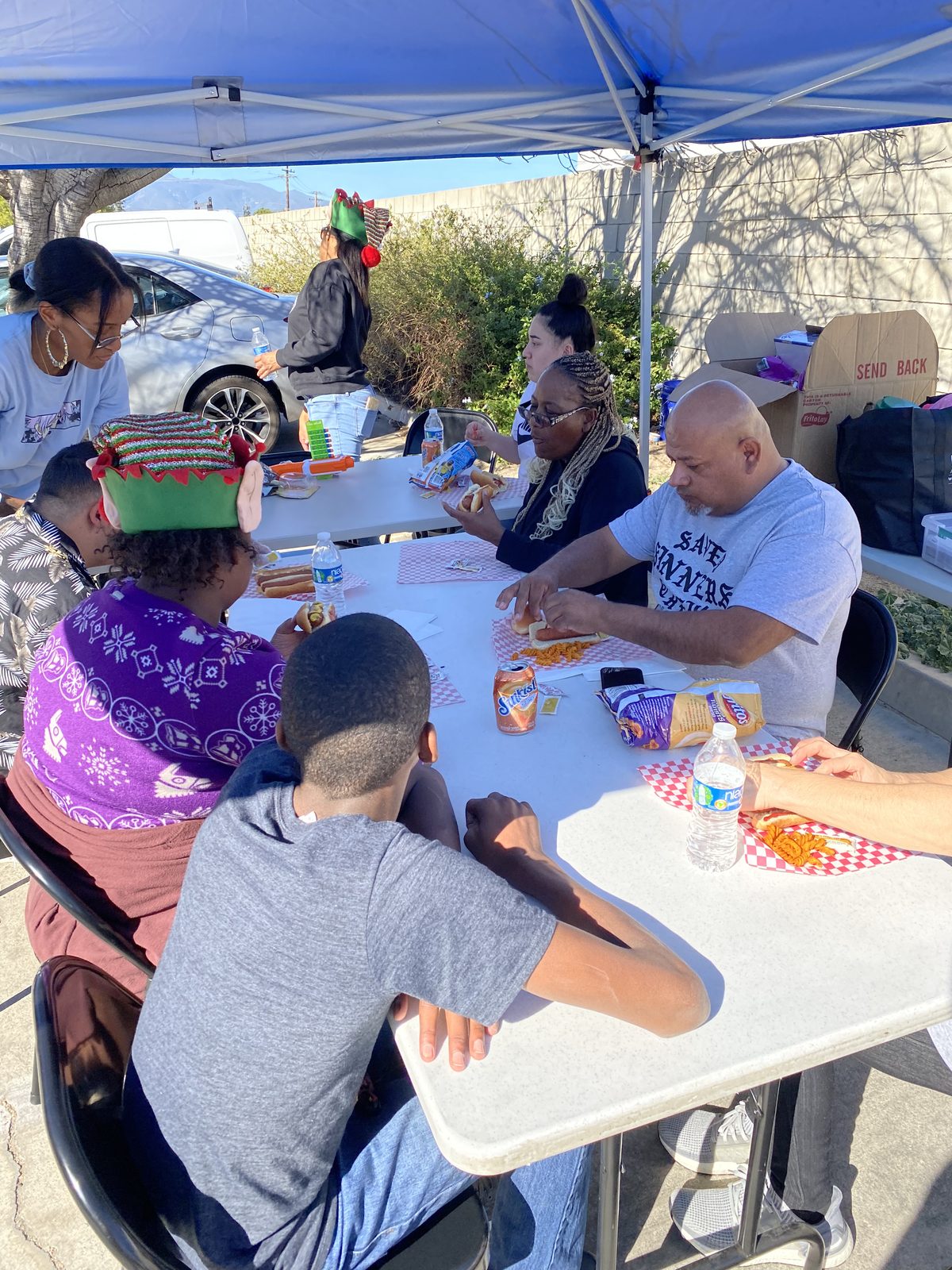 LPH community meal — serving families together under a tent
