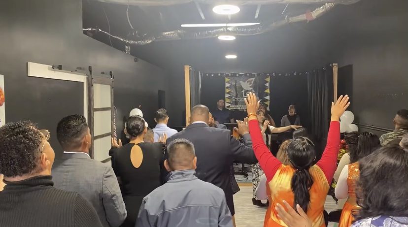 Congregation worshipping with hands raised at LPH Family Church